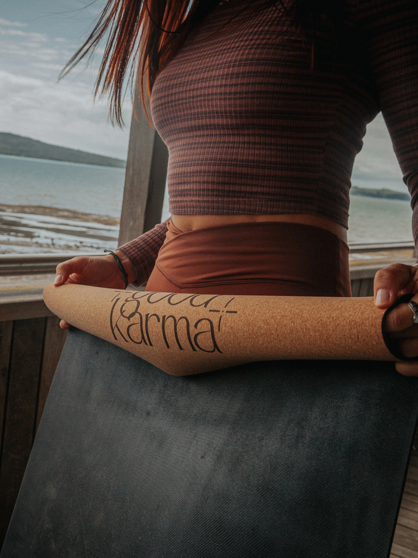 Girl rolling up Good Karma cork yoga mat with body alinement
