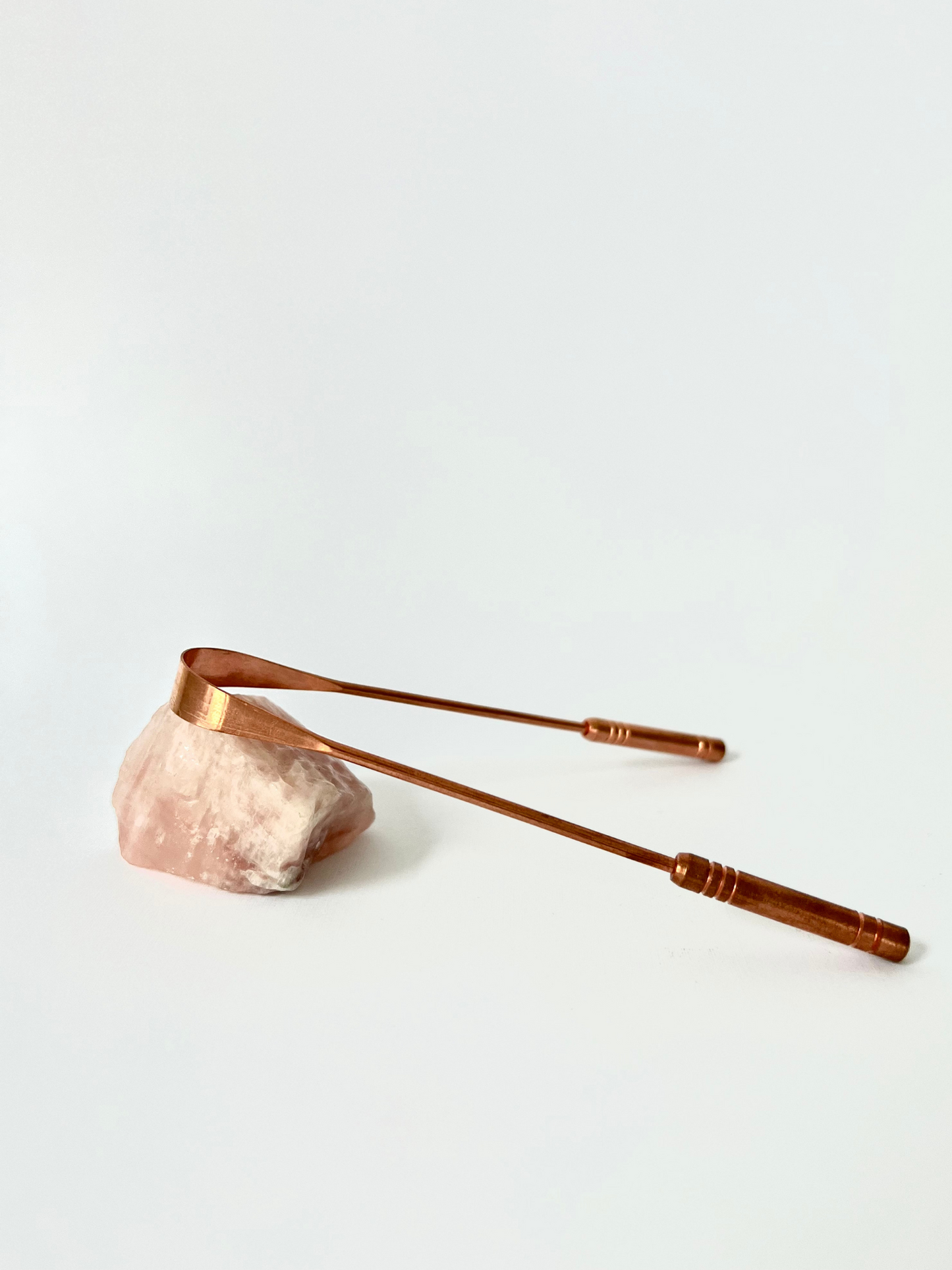 Good Karma Ayurvedic Copper Tongue Scraper Cleaner for Oral health on rose crystal stone