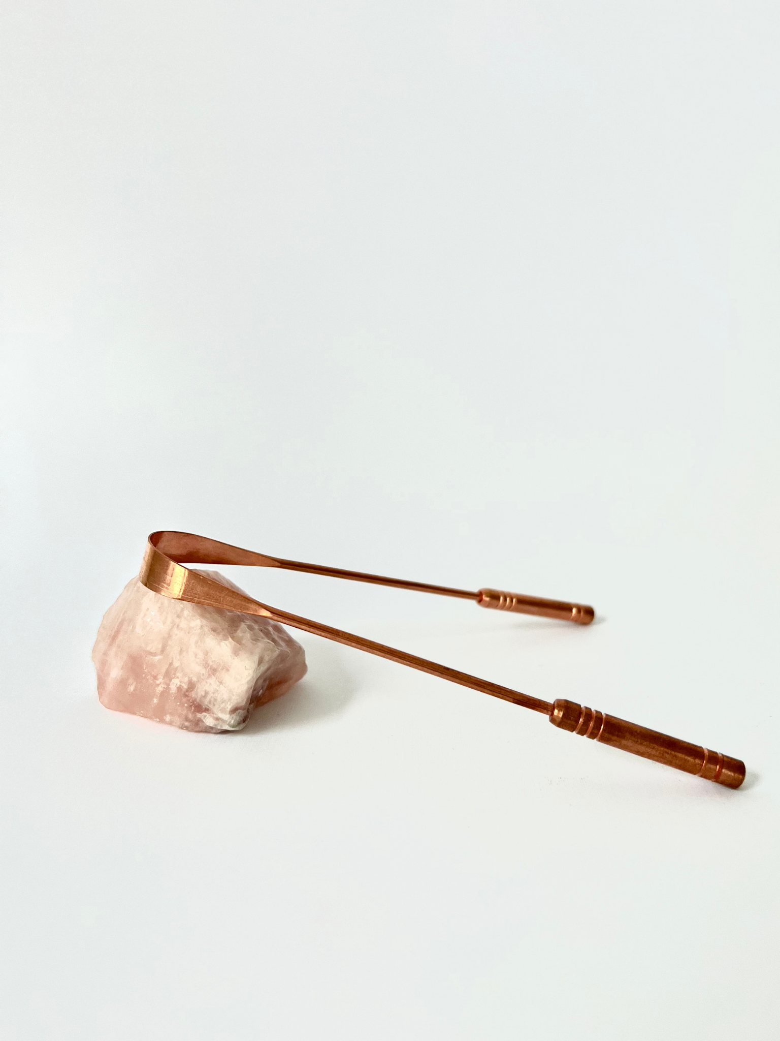 Good Karma Ayurvedic Copper Tongue Scraper Cleaner for Oral health on rose crystal stone
