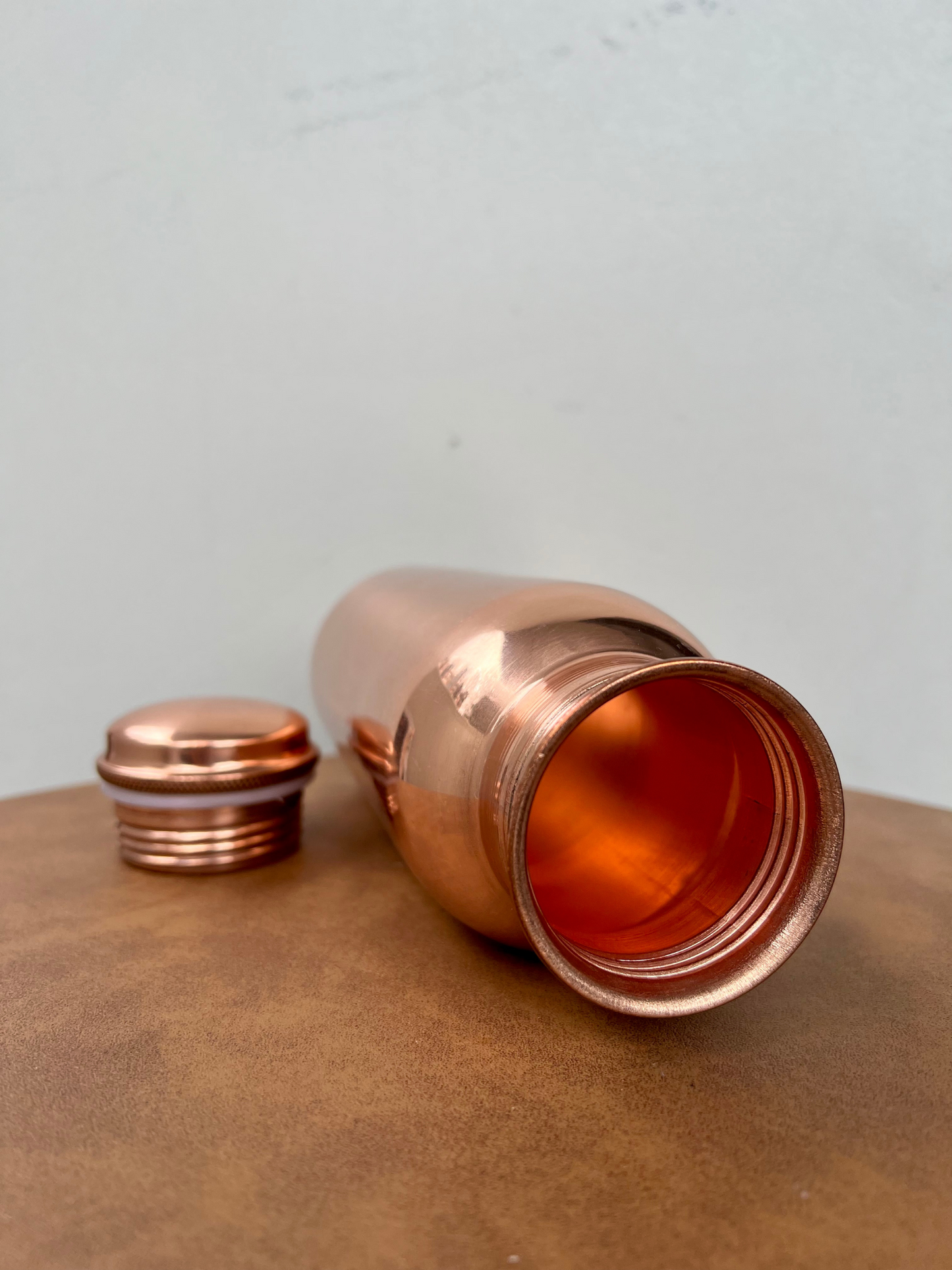Ayurvedic pure copper water bottle glossy design 700 ml opened with the lid on the side 
