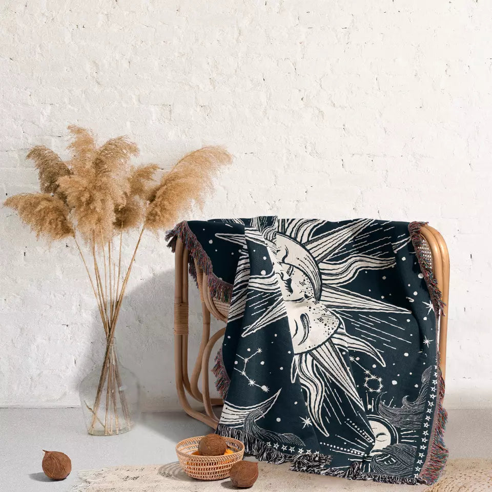 sun and moon and star sky pattern tapestries with tassels on the rattan table