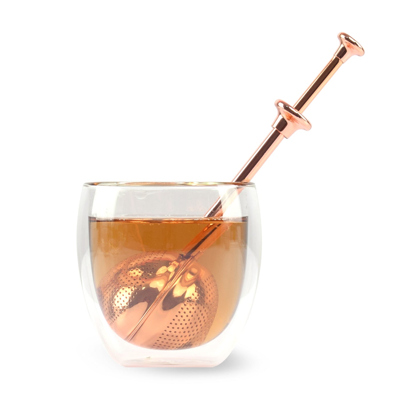Good Karma tea infuser ball rose gold color inside transparent cup of tea