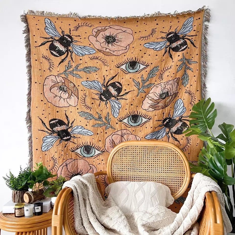 Woven Bohemian Quilt with Colorful Bees and flowers pattern Large boho tapestry with tassels on the corner Orange color Boho Quilt Colorful Bohemian Tapestries with tassels on the wall like art wall hanging , behind the chair