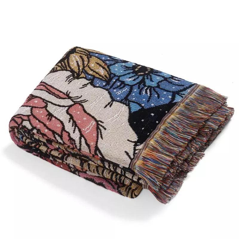 Flowers pattern on black background fabric Woven Boho Quilt Colorful Bohemian Tapestries with tassels folded on white background