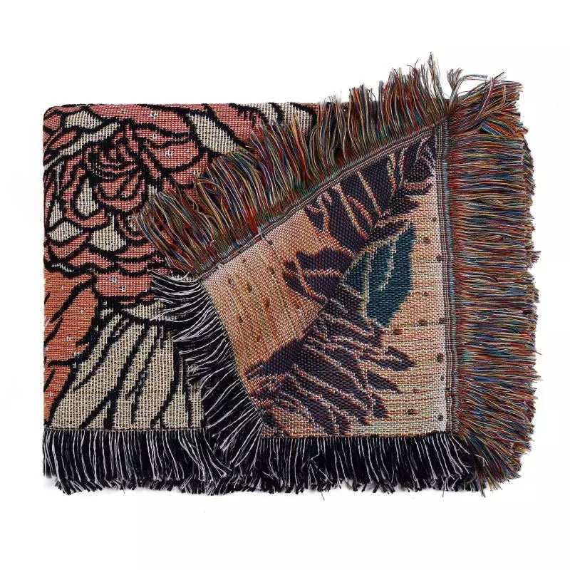 Flowers pattern on black background fabric Woven Boho Quilt Colorful Bohemian Tapestries with tassels folded on white background