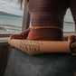 Girl rolling up Good Karma cork yoga mat with body alinement 