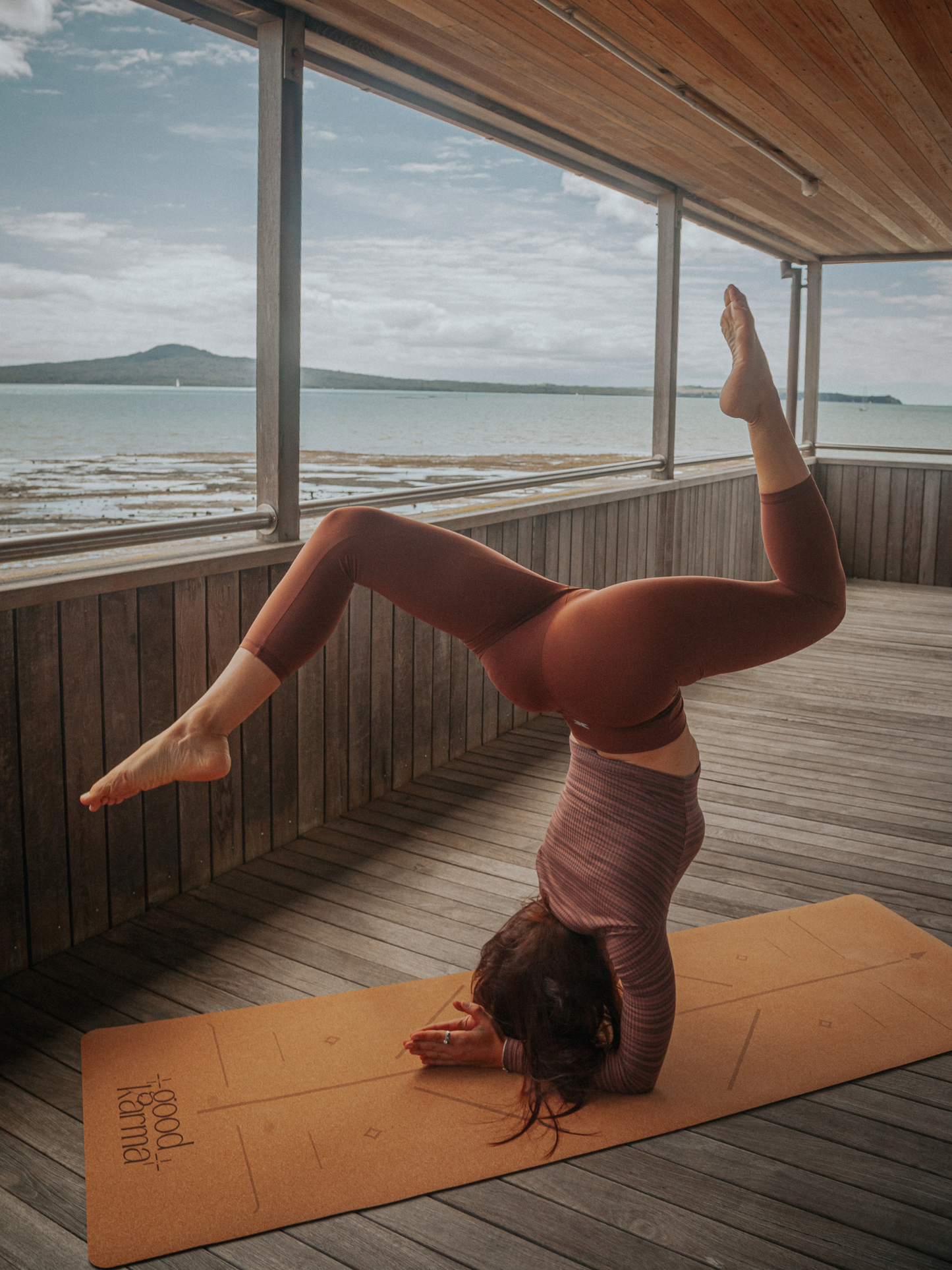 Girl doing handstand practice on Good Karma cork yoga mat with body alinement 