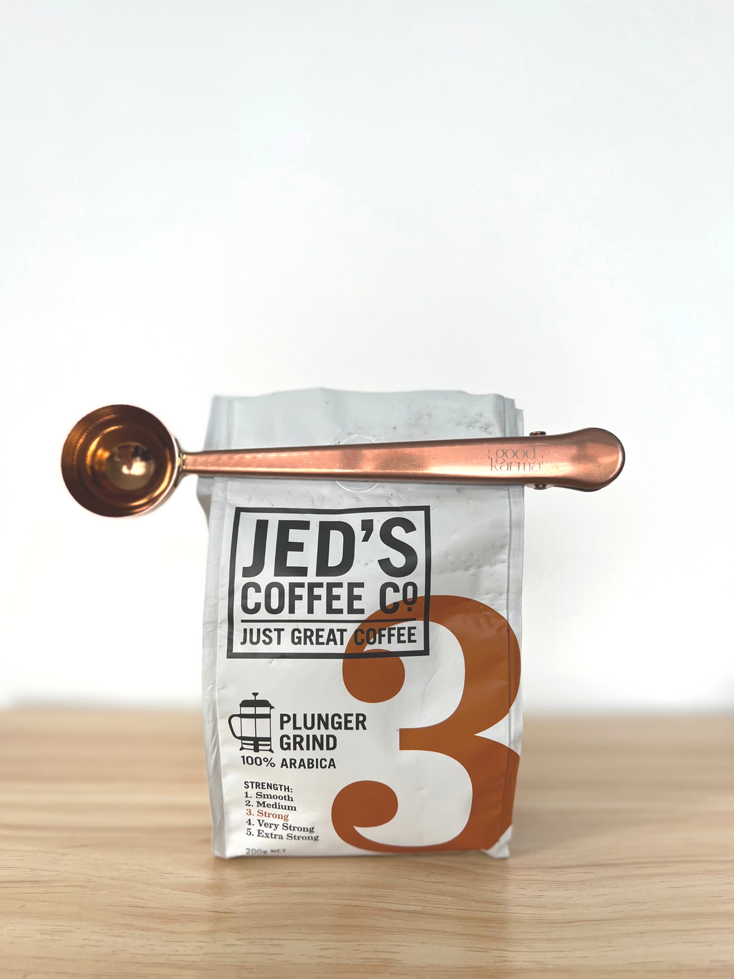 Good Karma Measuring Spoon Scoop With a Clip Stainless Steal Copper Color on Jed's Coffee bag