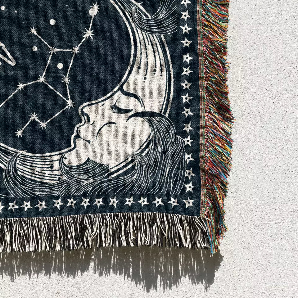 sun and moon and star sky pattern boho woven beach mat with tassels on the white wall
