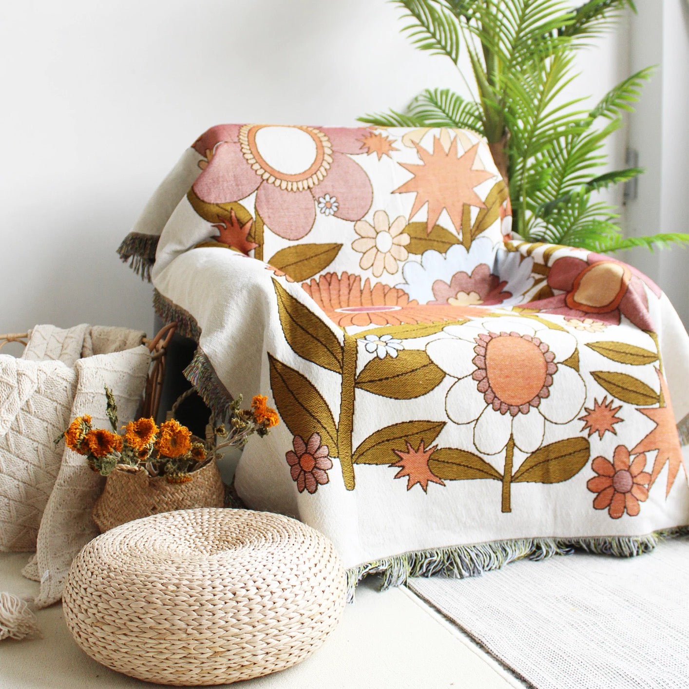 Good Karma Floral Boho throw nz, orange and brown Floral pattern Woven Boho Quilt nz Colorful Bohemian Tapestries with tassels on white background on the chair