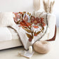 orange and brown Floral pattern Woven Boho Quilt Colorful Bohemian Tapestries with tassels on white background thrown on the corner of whine sofa