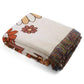 Good Karma Floral Boho throw nz, orange and brown Floral pattern Woven Boho Quilt nz Colorful Bohemian Tapestries with tassels on white background folded