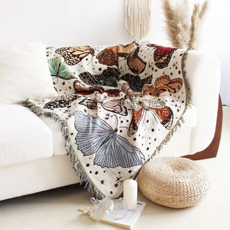 Colorful Butterflies pattern on white background Woven Bohemian Quilt Modern Boho Blanket nz on the corner of white sofa