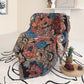 Flowers pattern on black background fabric Woven Boho Quilt Colorful Bohemian Tapestries with tassels thrown on the chair and covering the chair