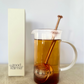Good Karma tea infuser ball is 2-in-1 scoop and a strainer rose gold color inside transparent cup of tea with white box
